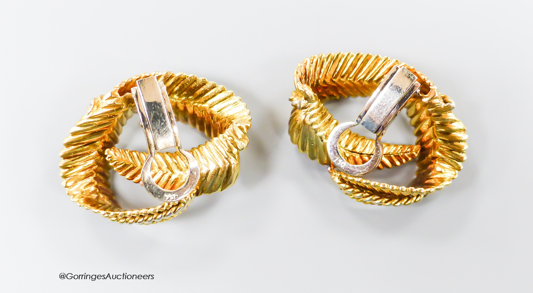 A pair of textured 750 yellow metal 'fern knot' ear clips, 27mm, 16.8 grams.